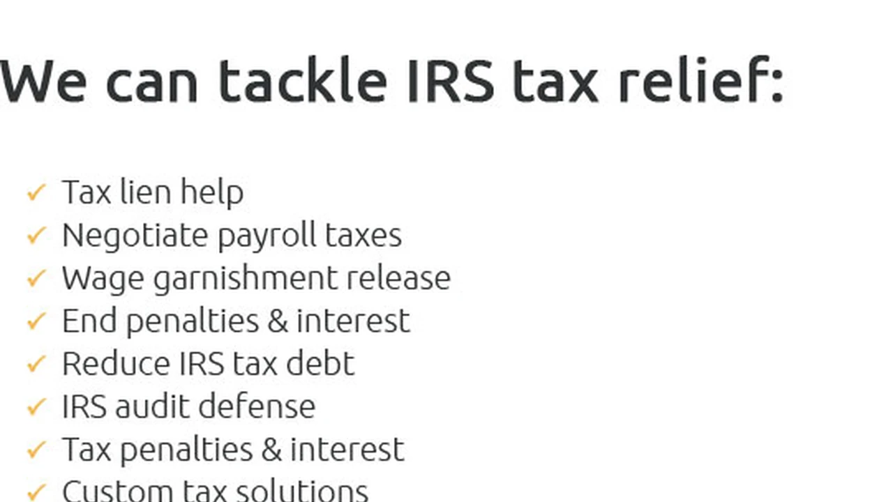 overhead view of corned beef sliced and on a platter with cabbage, potatoes, and carrots