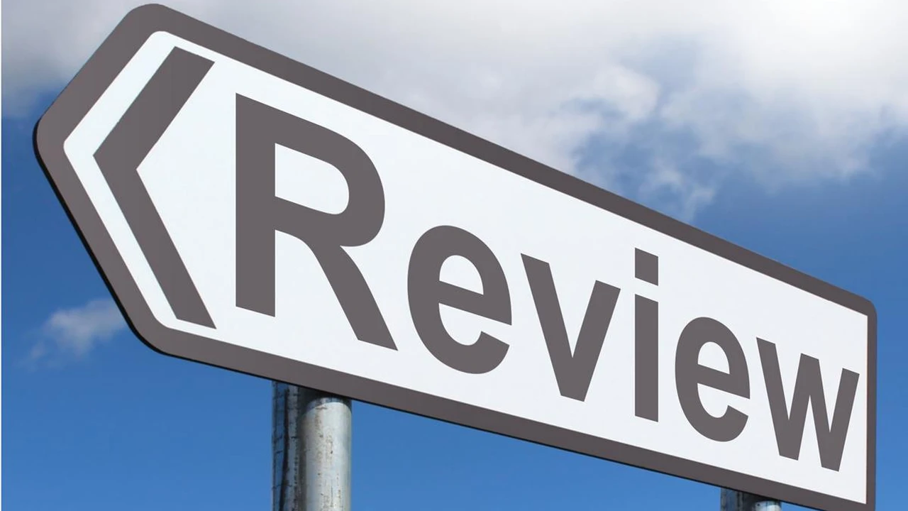 Close up on a plate of mashed potatoes, topped with baked pork chops with cream of mushroom soup, and a side of green beans.