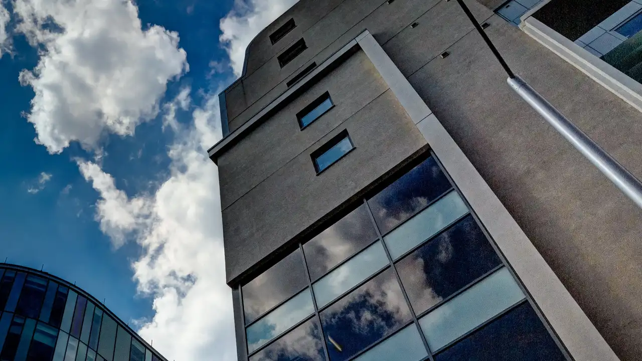 Close up on a plate of mashed potatoes, topped with baked pork chops with cream of mushroom soup, and a side of green beans.